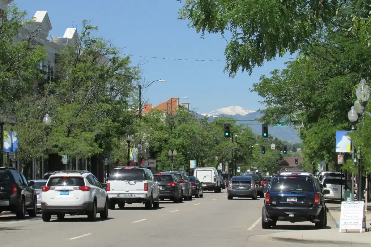 Main Street in historic downtown Littleton, CO with the Front Range in the background